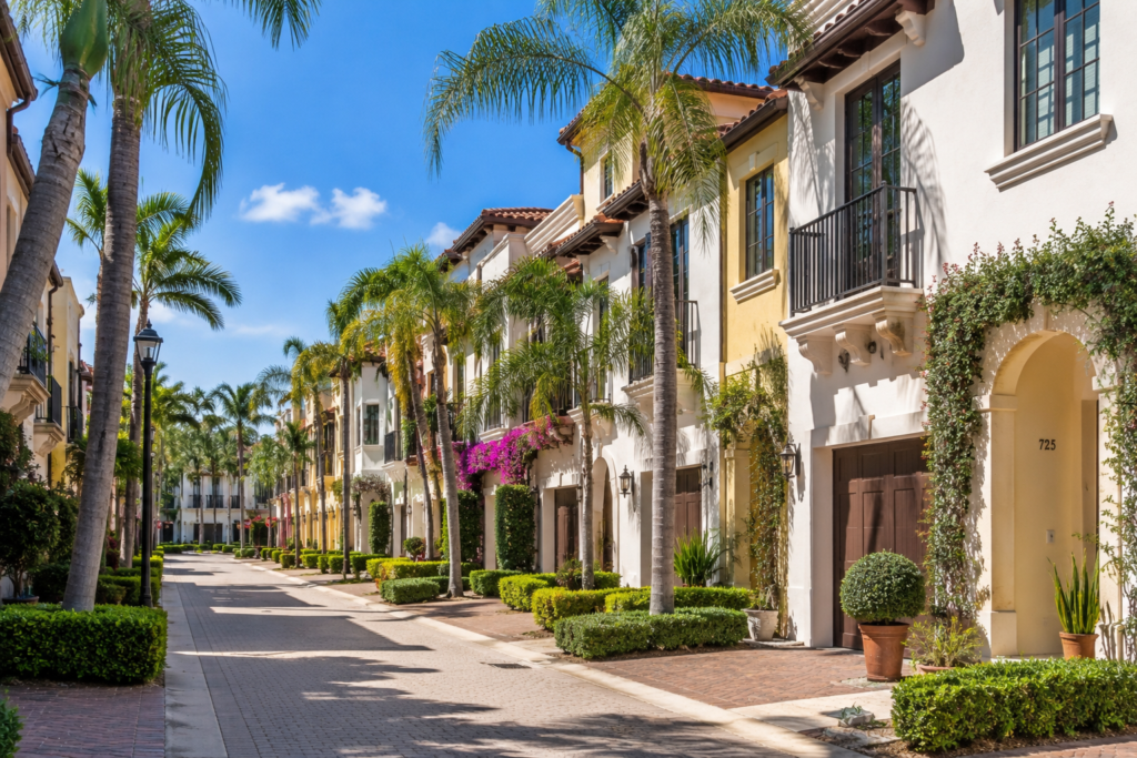 Mediterranean-style townhomes on a landscaped street