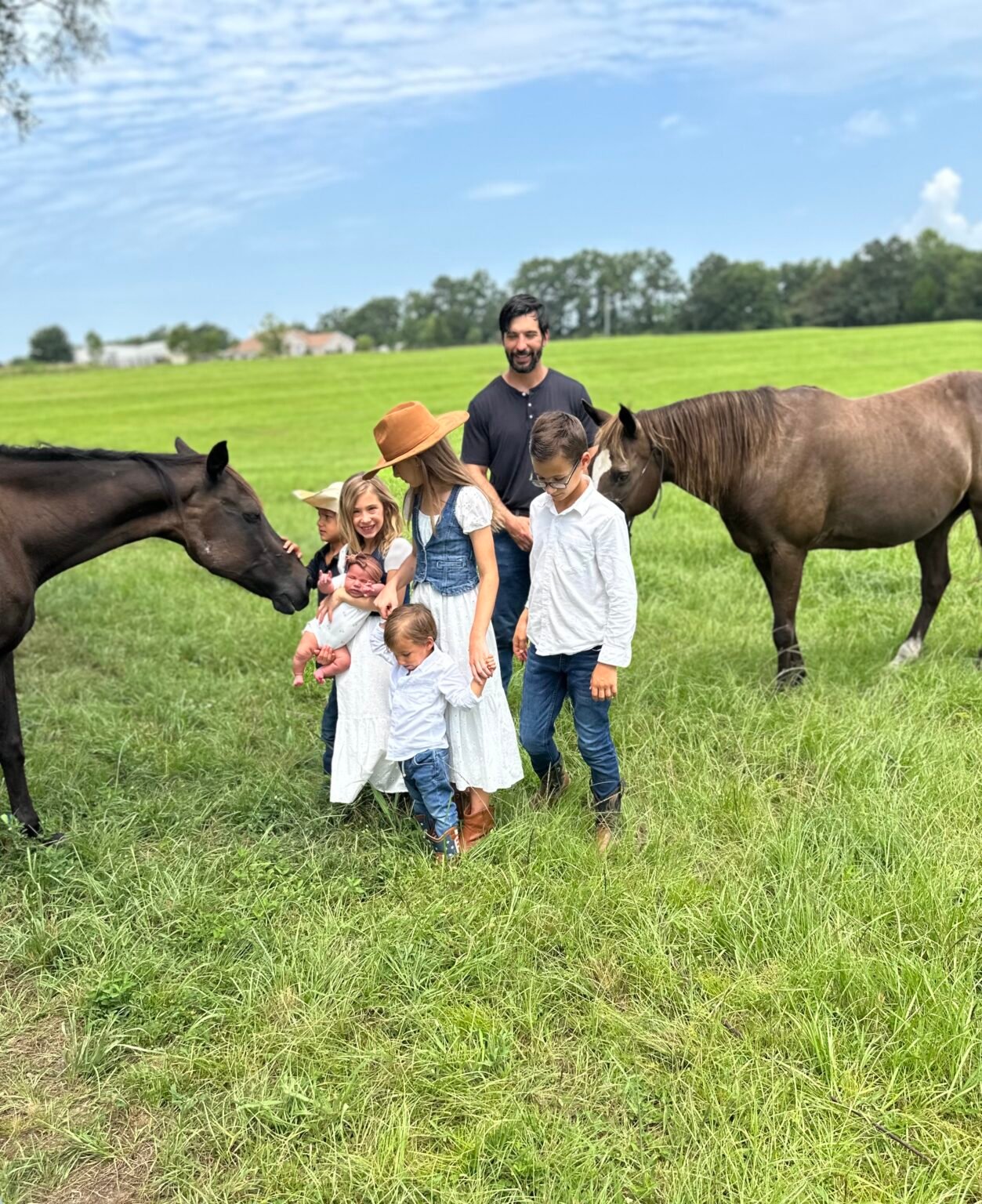 The broker with his children and a horse in an open pasture
